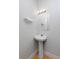 Bathroom with pedestal sink and stylish lighting at 1340 Deerpath Trl, Franktown, CO 80116
