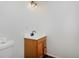 Bathroom with a white sink, a wood vanity, and a toilet at 1340 Deerpath Trl, Franktown, CO 80116