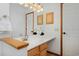 Bathroom featuring a vanity with double sinks and a view of a door in the mirror at 1340 Deerpath Trl, Franktown, CO 80116