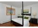 Bedroom features a four-poster bed with stylish lamps on the bedside tables at 1340 Deerpath Trl, Franktown, CO 80116