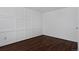 Bedroom featuring wood paneling and hardwood floors at 1340 Deerpath Trl, Franktown, CO 80116