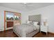Comfortable bedroom with hardwood floors, plush bed, and access to outdoor space at 1340 Deerpath Trl, Franktown, CO 80116