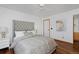 Bright bedroom featuring hardwood floors, ceiling fan, and tasteful decor at 1340 Deerpath Trl, Franktown, CO 80116