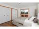 Cozy bedroom with hardwood floors, closets, and sliding door leading to patio with hot tub at 1340 Deerpath Trl, Franktown, CO 80116