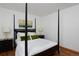 Bedroom featuring a four-poster bed with modern lamps on the bedside tables at 1340 Deerpath Trl, Franktown, CO 80116