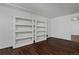 Bedroom with hardwood floors, white trim, and shelving at 1340 Deerpath Trl, Franktown, CO 80116