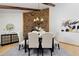 Spacious dining room with stone accent wall and contemporary chandelier above table at 1340 Deerpath Trl, Franktown, CO 80116