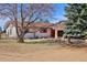 Charming ranch-style home featuring stone accents, a landscaped yard, and a serene, inviting atmosphere at 1340 Deerpath Trl, Franktown, CO 80116