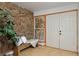 Inviting foyer featuring a stone wall, tile flooring, bench seating and entry to home at 1340 Deerpath Trl, Franktown, CO 80116