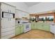 Charming kitchen with bay window and verdant views, as well as ample counter space and stylish cabinetry at 1340 Deerpath Trl, Franktown, CO 80116