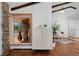 Stylish living room with hardwood floors, stone details, and views of the outdoor deck at 1340 Deerpath Trl, Franktown, CO 80116