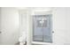 Bathroom featuring a glass-enclosed shower, toilet, and view of the double sink vanity at 46533 Sunflower Ln, Bennett, CO 80102