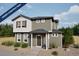 Charming two-story home with gray siding, white trim, and professionally landscaped front yard at 46533 Sunflower Ln, Bennett, CO 80102