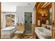 Luxurious bathroom featuring marble countertops, a soaking tub, walk-in shower, and designer fixtures at 45 Charlou Cir, Cherry Hills Village, CO 80111