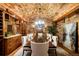 Elegant dining room features stone walls, a brick ceiling, a chandelier, and a large wooden table at 45 Charlou Cir, Cherry Hills Village, CO 80111