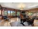 Spacious wood-paneled office features beautiful views and custom built-ins and large area rug at 45 Charlou Cir, Cherry Hills Village, CO 80111