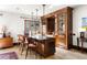 Charming kitchen island with seating, custom wood cabinetry, and pendant lighting at 45 Charlou Cir, Cherry Hills Village, CO 80111