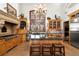 Gourmet kitchen featuring custom wood cabinetry, large island with seating, and professional-grade appliances at 45 Charlou Cir, Cherry Hills Village, CO 80111