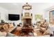 Cozy living room with a fireplace, comfortable seating, large TV, and traditional decor at 45 Charlou Cir, Cherry Hills Village, CO 80111