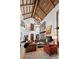 Elegant living room with high ceilings, large chandelier, fireplace, and large windows providing abundant light at 45 Charlou Cir, Cherry Hills Village, CO 80111