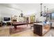 Expansive living area with a pool table, fireplace, elegant chandeliers, and views to the outside at 45 Charlou Cir, Cherry Hills Village, CO 80111