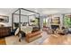 Spacious main bedroom suite with a four-poster bed, fireplace, sitting area, and plenty of natural light at 45 Charlou Cir, Cherry Hills Village, CO 80111