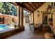 Outdoor dining area with a stone wall, ceiling fan, a waterfall feature and lush landscaping at 45 Charlou Cir, Cherry Hills Village, CO 80111