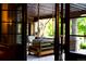 Relaxing covered patio with a hanging daybed, perfect for enjoying the serene outdoor setting at 45 Charlou Cir, Cherry Hills Village, CO 80111