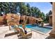 This luxurious pool features a rock waterfall and inviting lounge area with comfortable seating at 45 Charlou Cir, Cherry Hills Village, CO 80111