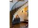 Elegant curved staircase with wrought iron railing and ambient lighting on display below at 45 Charlou Cir, Cherry Hills Village, CO 80111