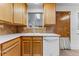 Kitchen features wood cabinets, tile backsplash, and white appliances at 3142 Uvalda St, Aurora, CO 80011