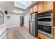 Galley kitchen with stainless steel appliances and wood cabinets at 3142 Uvalda St, Aurora, CO 80011