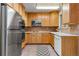 Bright kitchen features stainless steel appliances and light wood cabinets at 3142 Uvalda St, Aurora, CO 80011