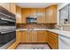 Modern kitchen with stainless steel appliances and wood cabinets at 3142 Uvalda St, Aurora, CO 80011