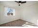 Bright bedroom with ceiling fan, neutral carpet, large window and neutral color scheme at 3829 Odessa St, Denver, CO 80249