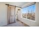 Bedroom with neutral carpet, large window, and doorway to bathroom at 3829 Odessa St, Denver, CO 80249