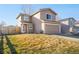 Inviting two-story home with a two-car garage and a well-manicured front yard in a suburban neighborhood at 3829 Odessa St, Denver, CO 80249