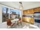 Cozy kitchen nook with breakfast table, bright light, and knotty wood cabinets with stainless steel appliances at 3829 Odessa St, Denver, CO 80249