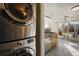 Open concept kitchen with modern laundry machines near a table and chairs at 3829 Odessa St, Denver, CO 80249