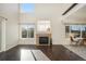 Inviting living room featuring hardwood floors, a fireplace, and lots of natural sunlight at 3829 Odessa St, Denver, CO 80249