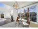 Bright living room with fireplace, breakfast table, and large windows for ample natural light at 3829 Odessa St, Denver, CO 80249