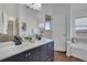 Bathroom with dual sinks, a glass shower, and a separate soaking tub at 4305 W 118Th Pl, Westminster, CO 80031