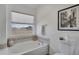 Bright bathroom showcasing a soaking tub, window, and modern fixtures at 4305 W 118Th Pl, Westminster, CO 80031