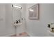 Elegant powder room with pedestal sink, stylish mirror, and neutral decor at 4305 W 118Th Pl, Westminster, CO 80031