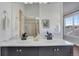 Bathroom with dual sinks, a glass shower, and a window at 4305 W 118Th Pl, Westminster, CO 80031