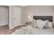 Cozy bedroom with a comfortable bed, two bedside tables, and light hardwood floors at 4305 W 118Th Pl, Westminster, CO 80031