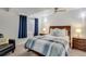 Bedroom featuring a bed, chair, window, and two nightstands with bedside lamps at 4305 W 118Th Pl, Westminster, CO 80031
