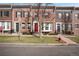 Brick townhomes with colorful shutters, manicured lawns, and a charming tree-lined street at 4305 W 118Th Pl, Westminster, CO 80031