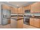Spacious kitchen with stainless steel appliances, island, and wood cabinets at 4305 W 118Th Pl, Westminster, CO 80031