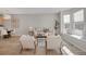 Open-concept living room with neutral decor, large windows, and a decorative area rug at 4305 W 118Th Pl, Westminster, CO 80031